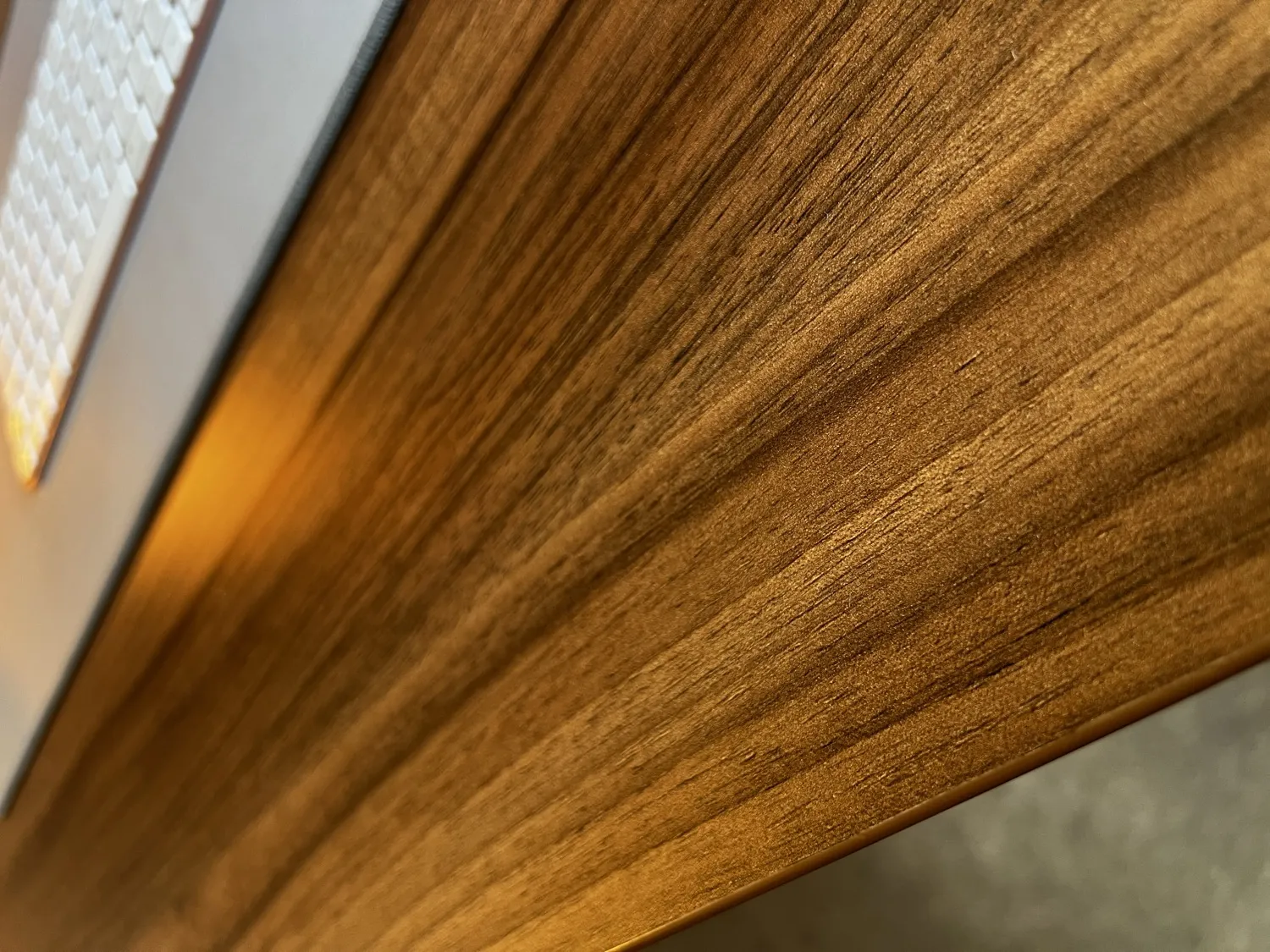 Close-up of the thick walnut-effect desktop edge on the Desktronic HomePro